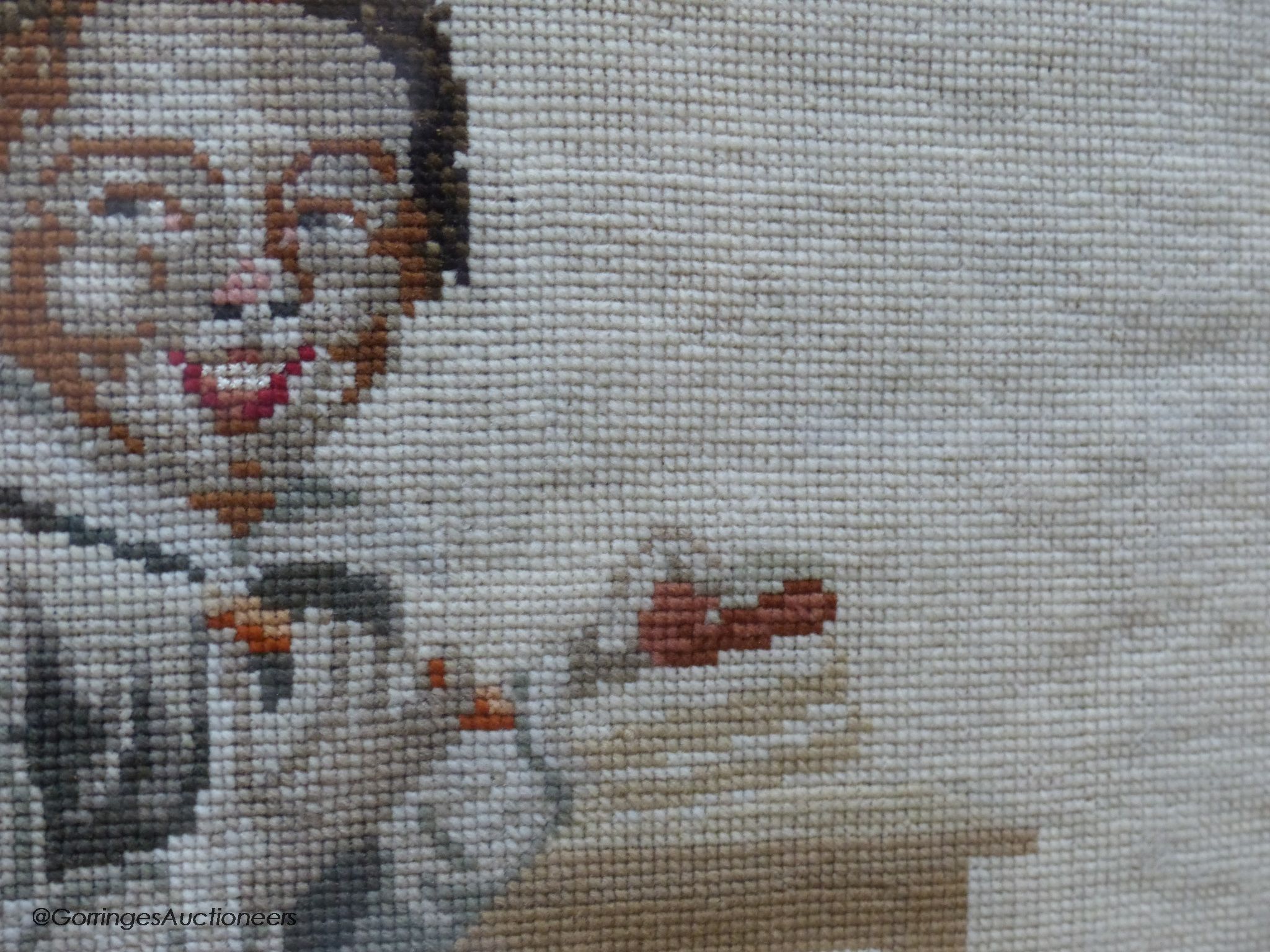 A Victoian petit-point needlework picture, two playful youths